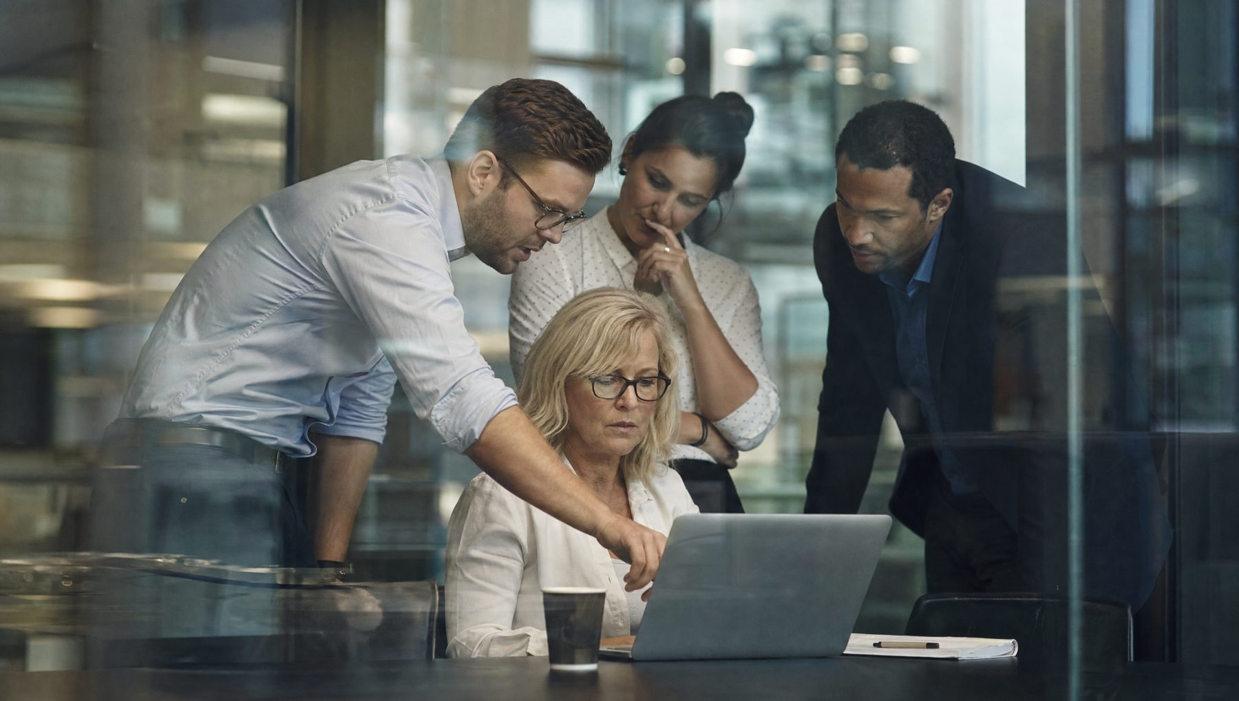 4 Executives working on a laptop